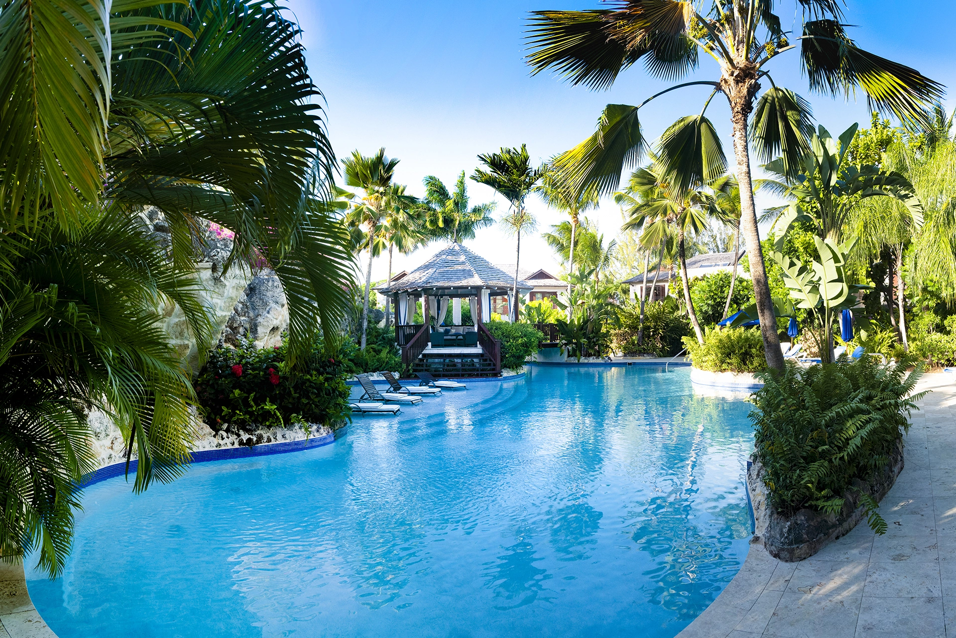 The sunlit swimming pool, tropical garden and gazebo at Claridges 3